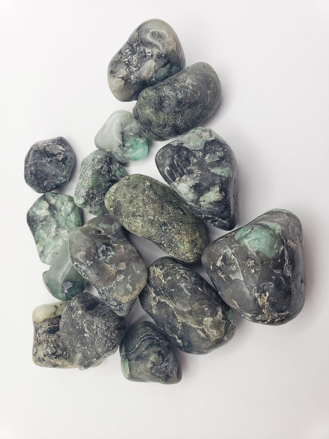 emerald in matrix stones on white background