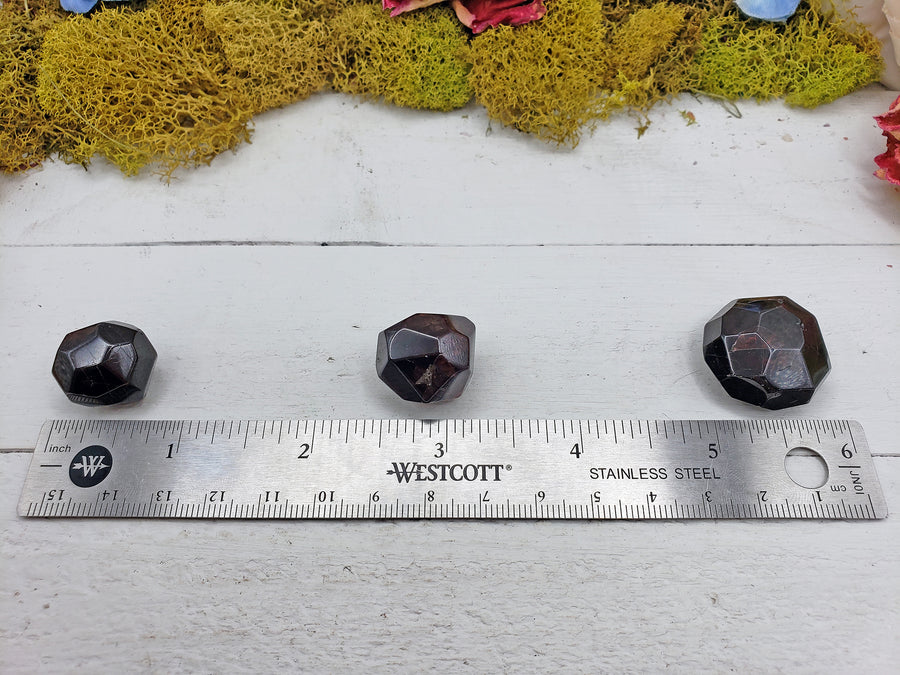 ruler comparing size of 3 garnet crystals