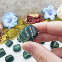fuchsite crystal pinched between fingers