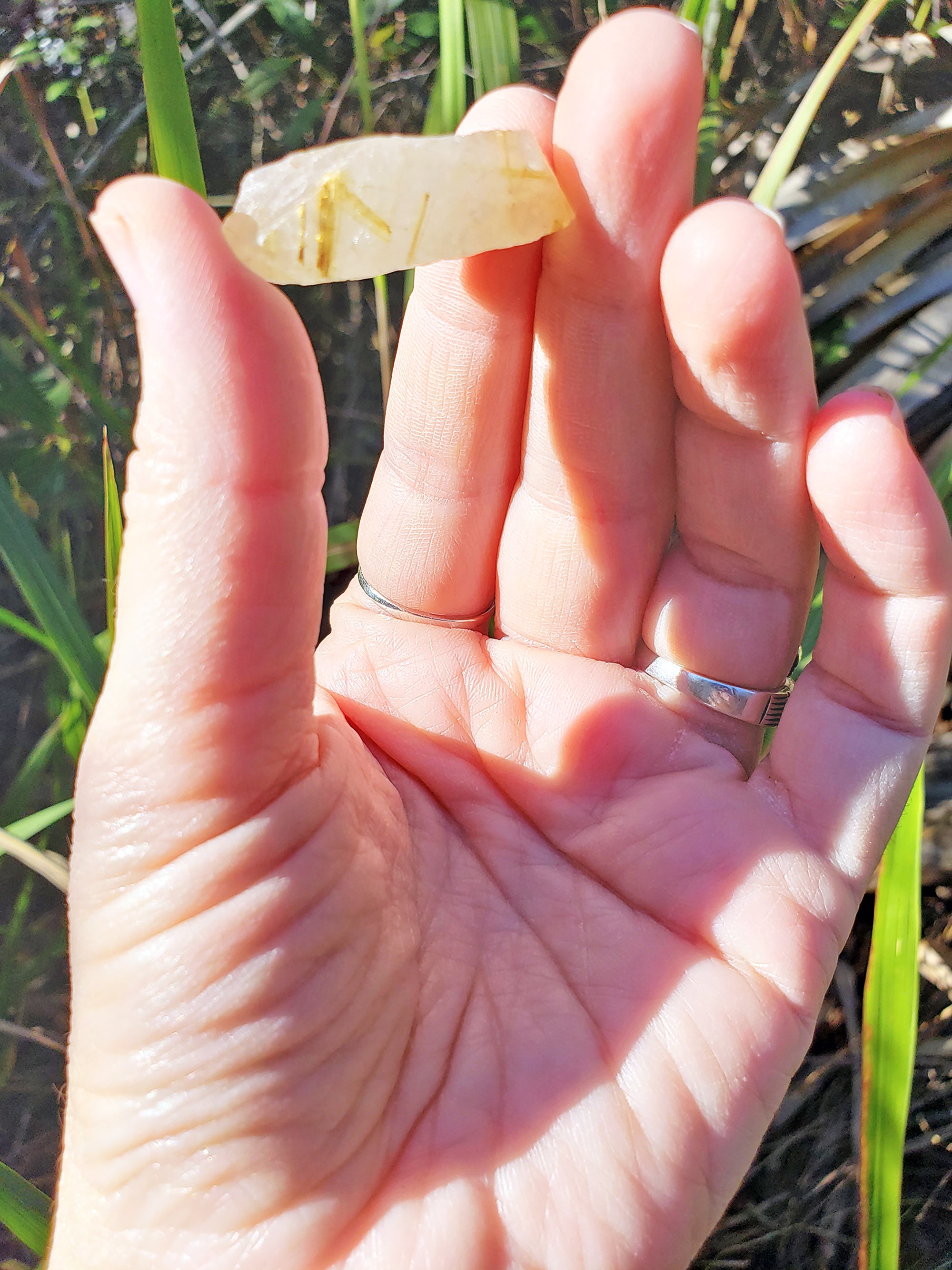 Gold Rutile Quartz Stone in hand