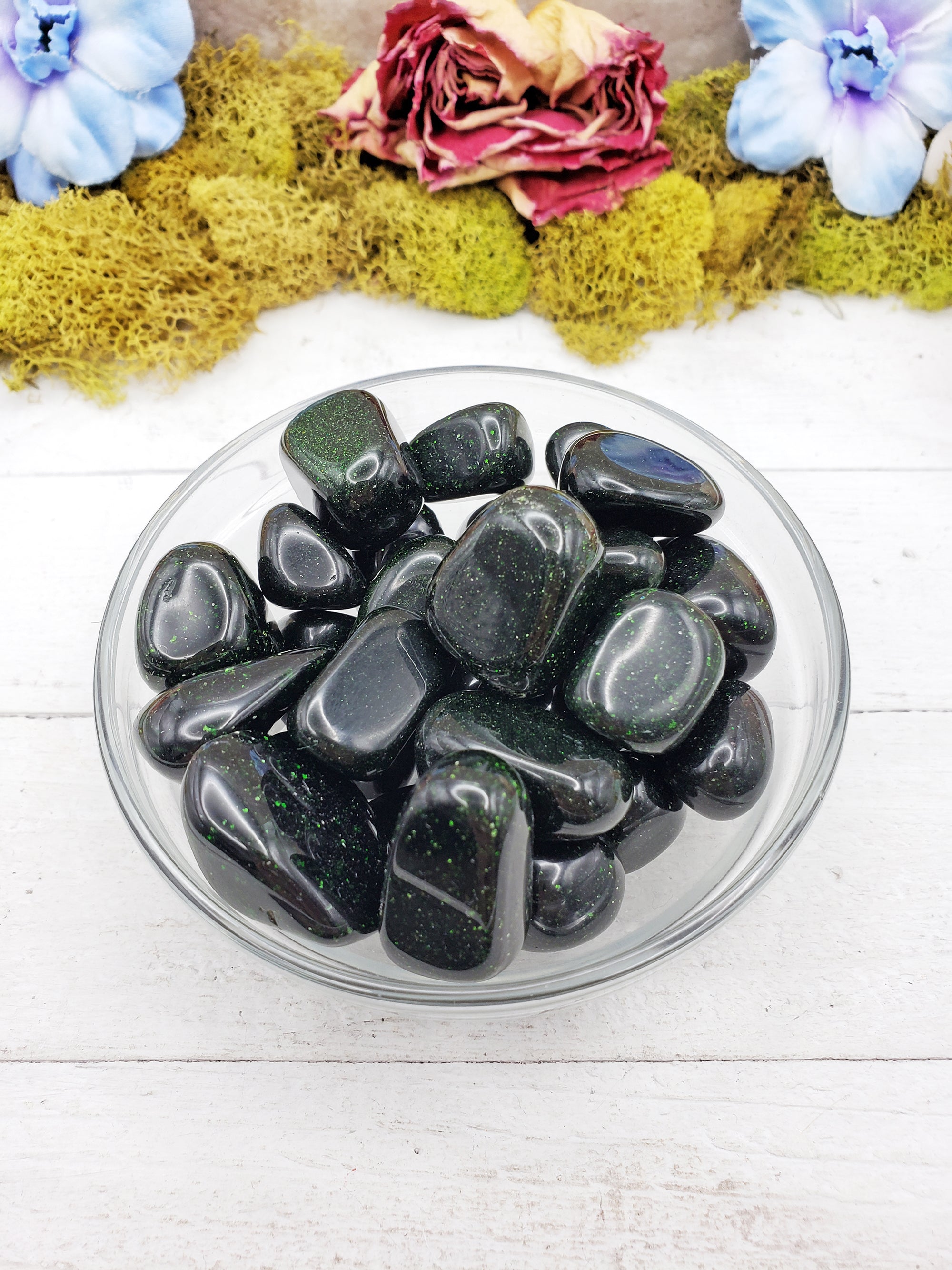 green goldstone crystals in glass bowl