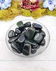 green goldstone crystals in glass bowl