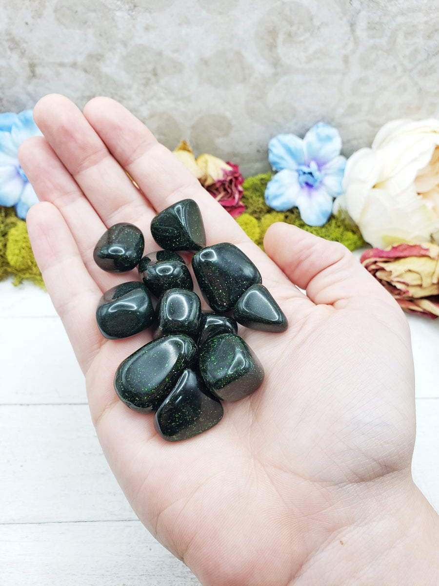 green goldstone crystals in hand