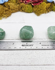 green included quartz crystal by ruler