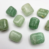 green included quartz crystal on white background