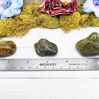 green opal stones by ruler