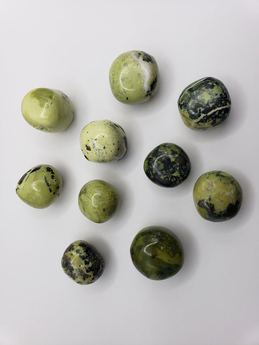 green serpentine stones on white background