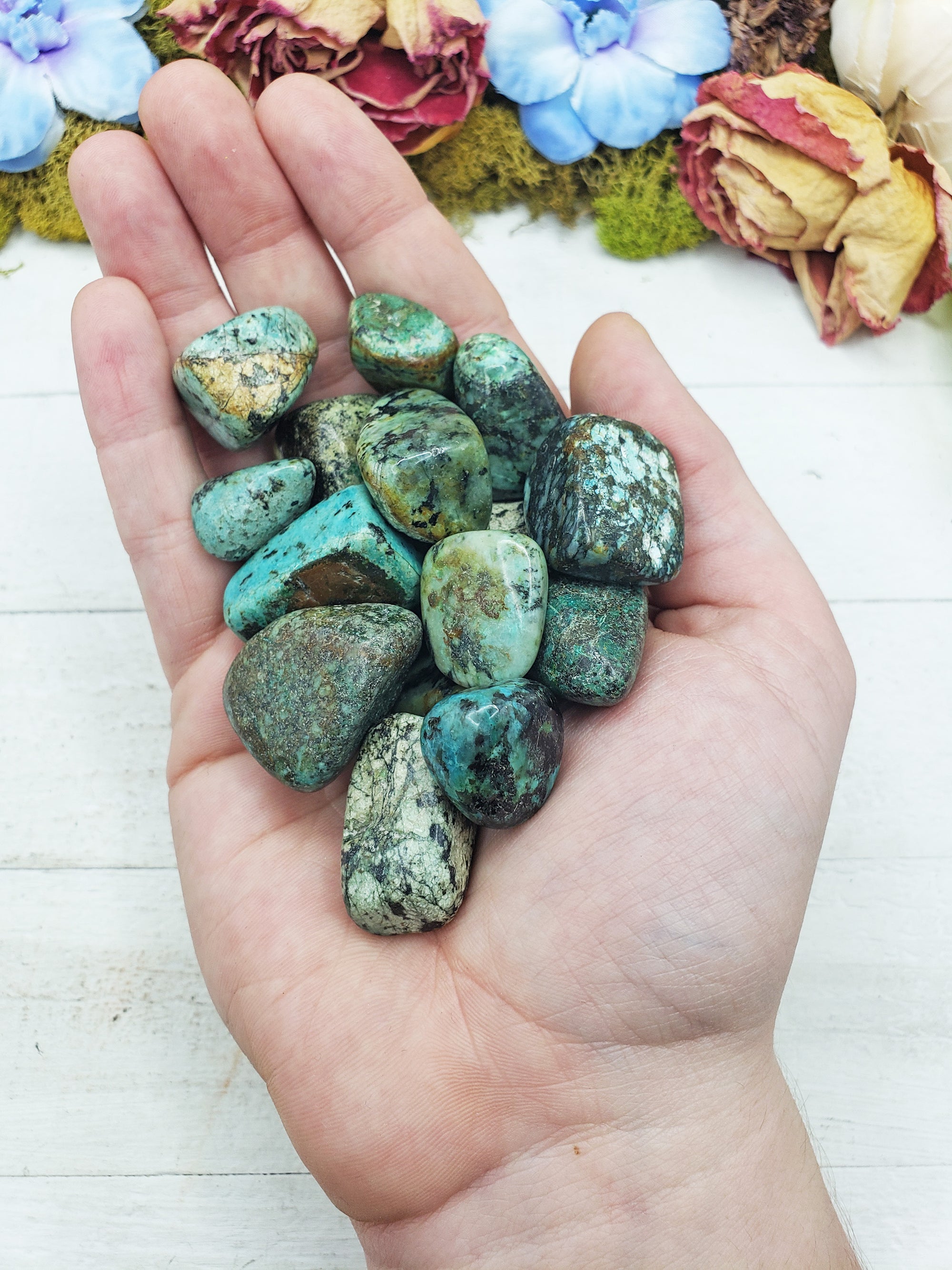 african turquoise stones in hand