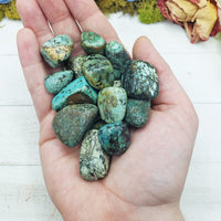 african turquoise stones in hand