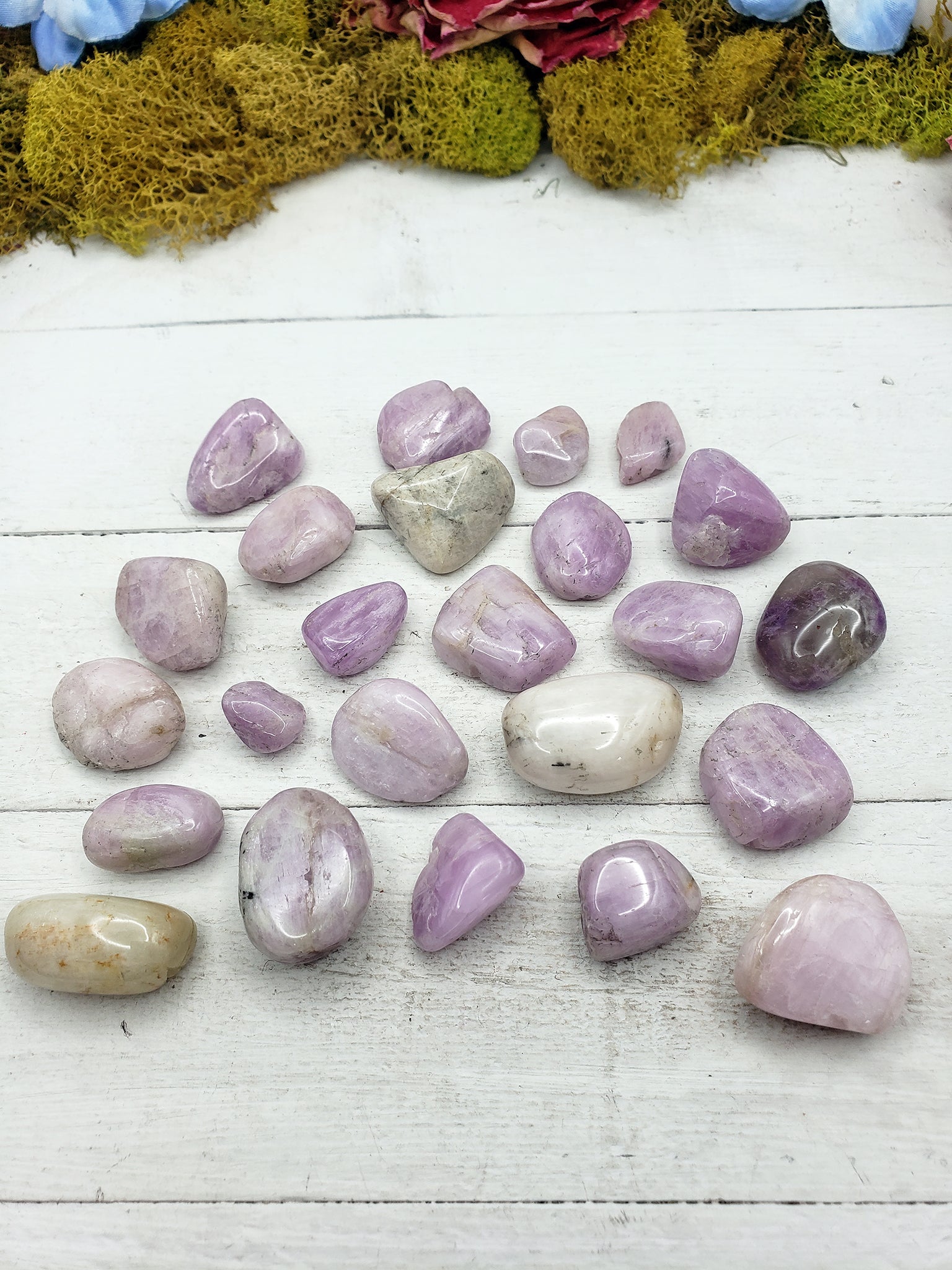 tumbled kunzite crystal pieces on display