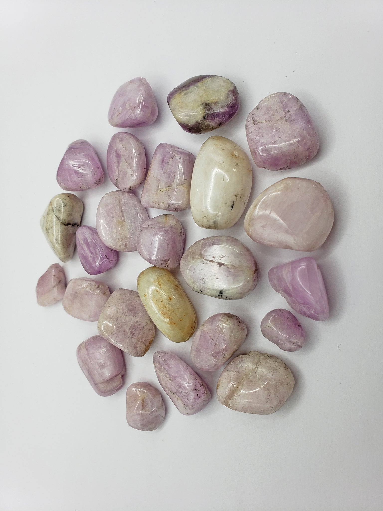 tumbled kunzite crystal pieces on display