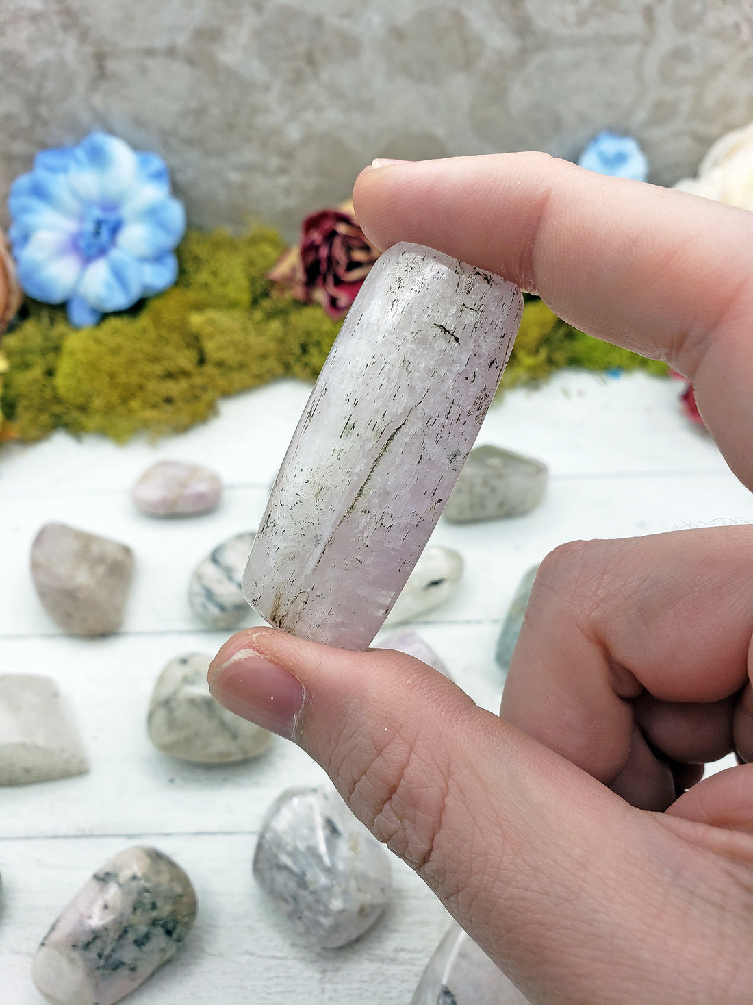 kunzite stone pinched in hand