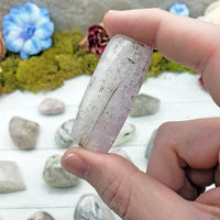 kunzite stone pinched in hand