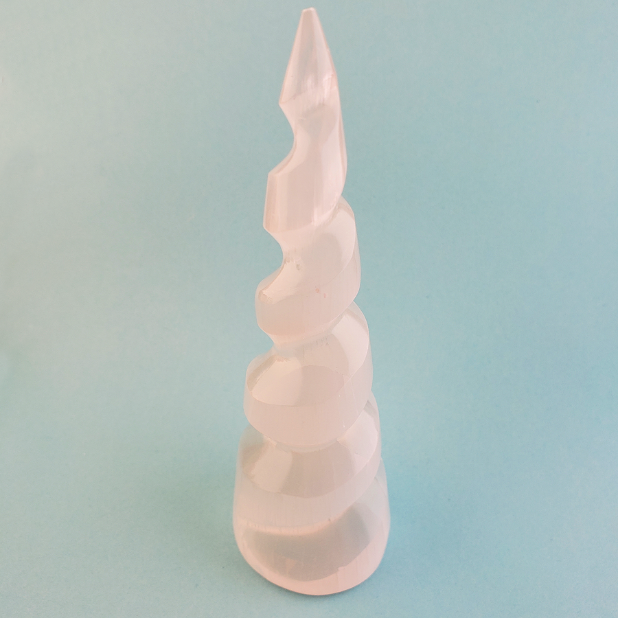 White Selenite Unicorn Horn Spiral Crystal Tower - One 5.5 Inch Tower - On Blue Background
