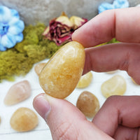 gold quartz crystal between fingers