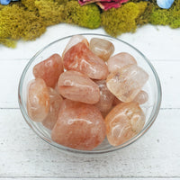 light strawberry quartz stones in glass bowl