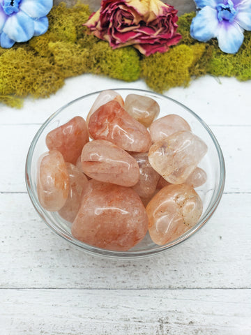 light strawberry quartz stones in glass bowl