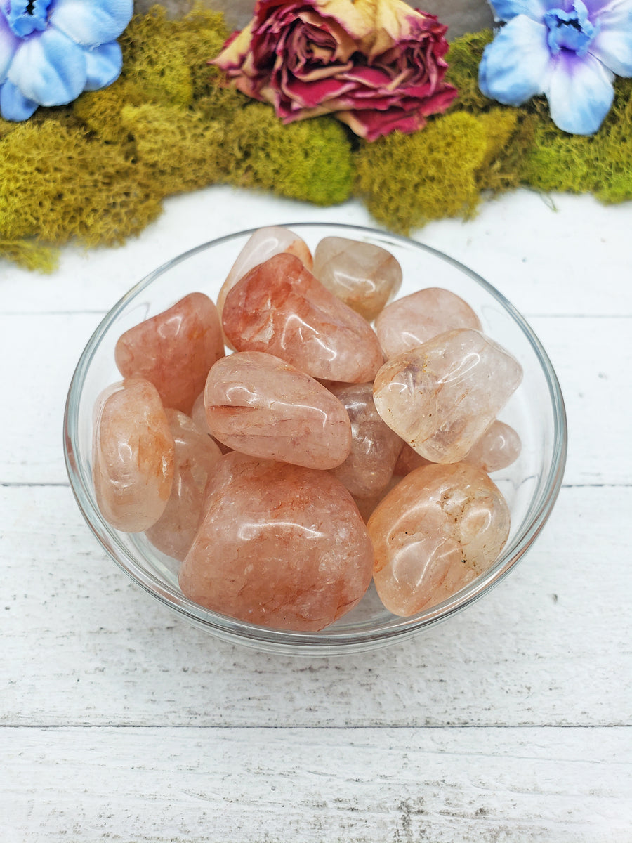 light strawberry quartz stones in glass bowl
