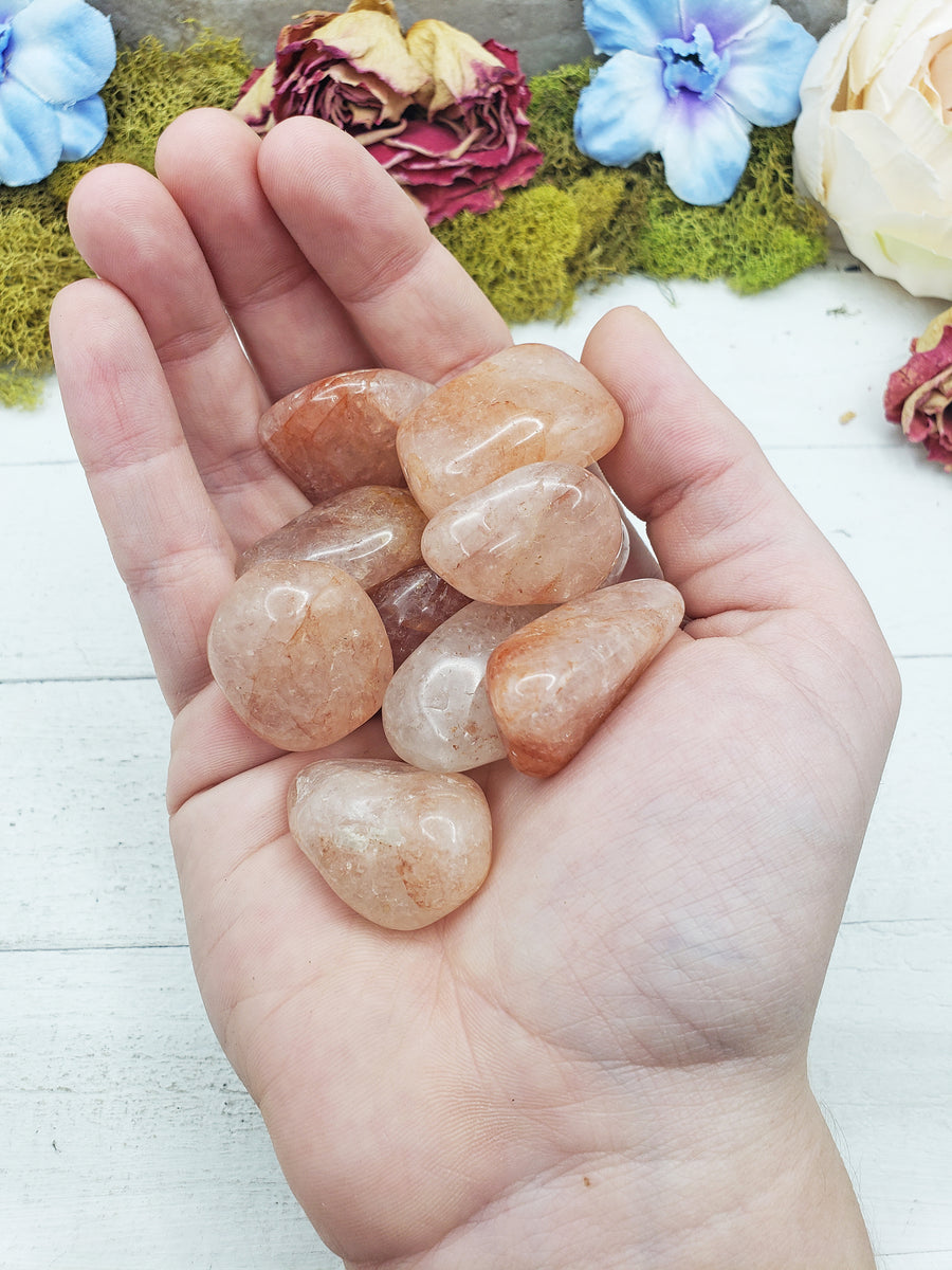 light strawberry quartz stones in hand