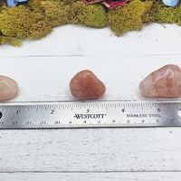 light strawberry quartz stones by ruler
