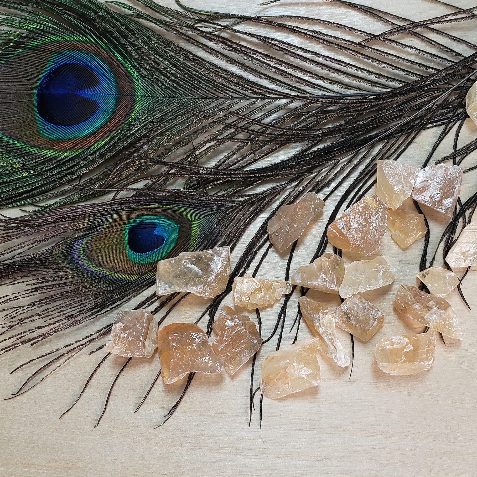 Honey Calcite Natural Raw Crystals Rough Gemstones - 3 Mini Stones - On Wooden Board with Peacock Feathers