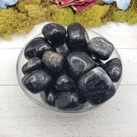 black tourmaline crystals in glass bowl
