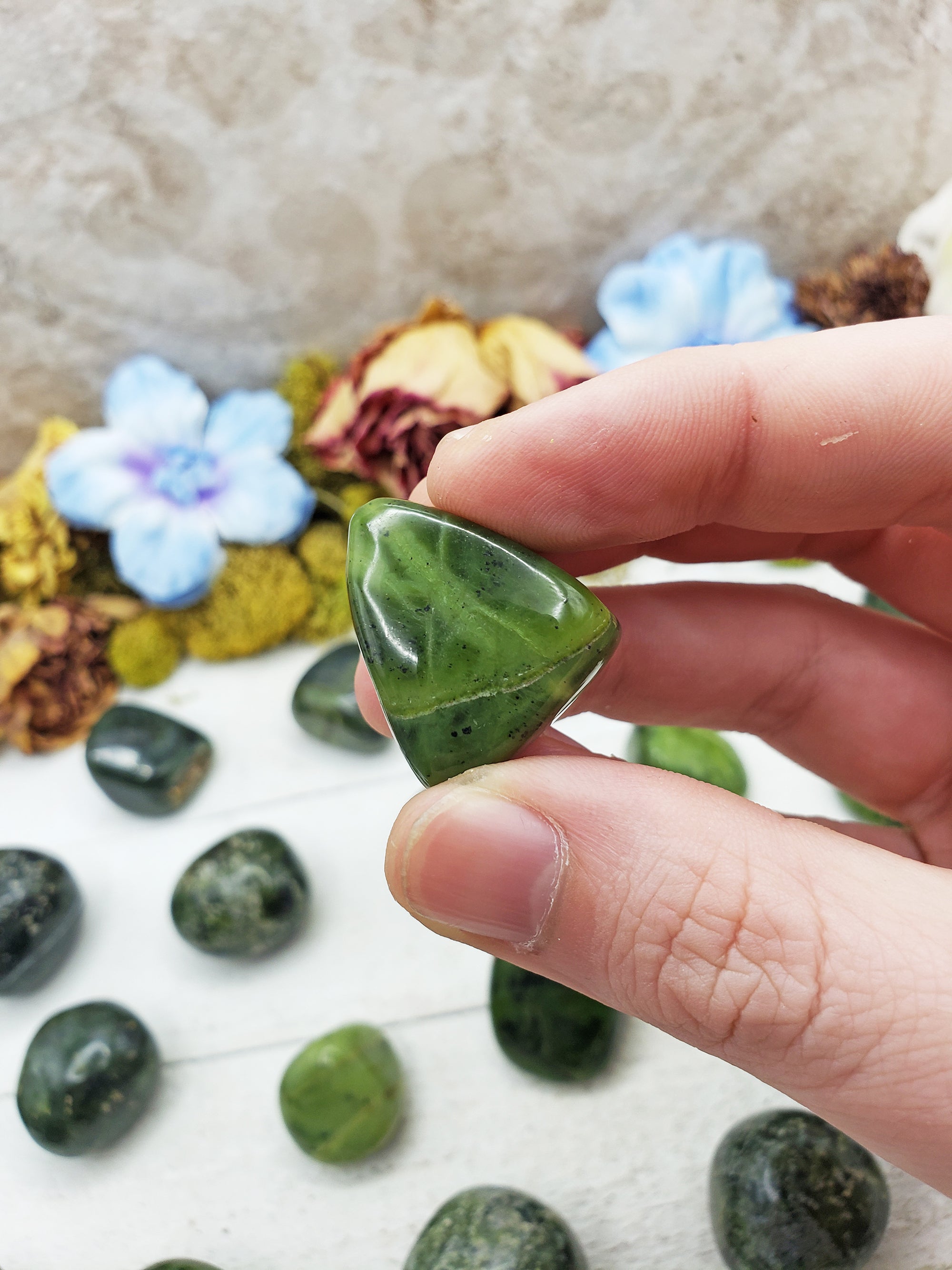 nephrite jade stone between fingers