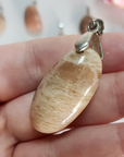 Peach Moonstone Crystal Pendant Natural Gemstone Jewelry - Close Up of Minor Flash on Peach Moonstone Pendant