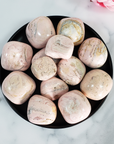 Pink Rhodochrosite Crystal Natural Gemstone Tumbled Stone | Multiple Sizes - Seen from Above in Black Ceramic Dish
