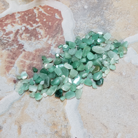 Green Aventurine Polished Gemstone Chips - By the Ounce - Gemstone Chips Spread Out on Stone