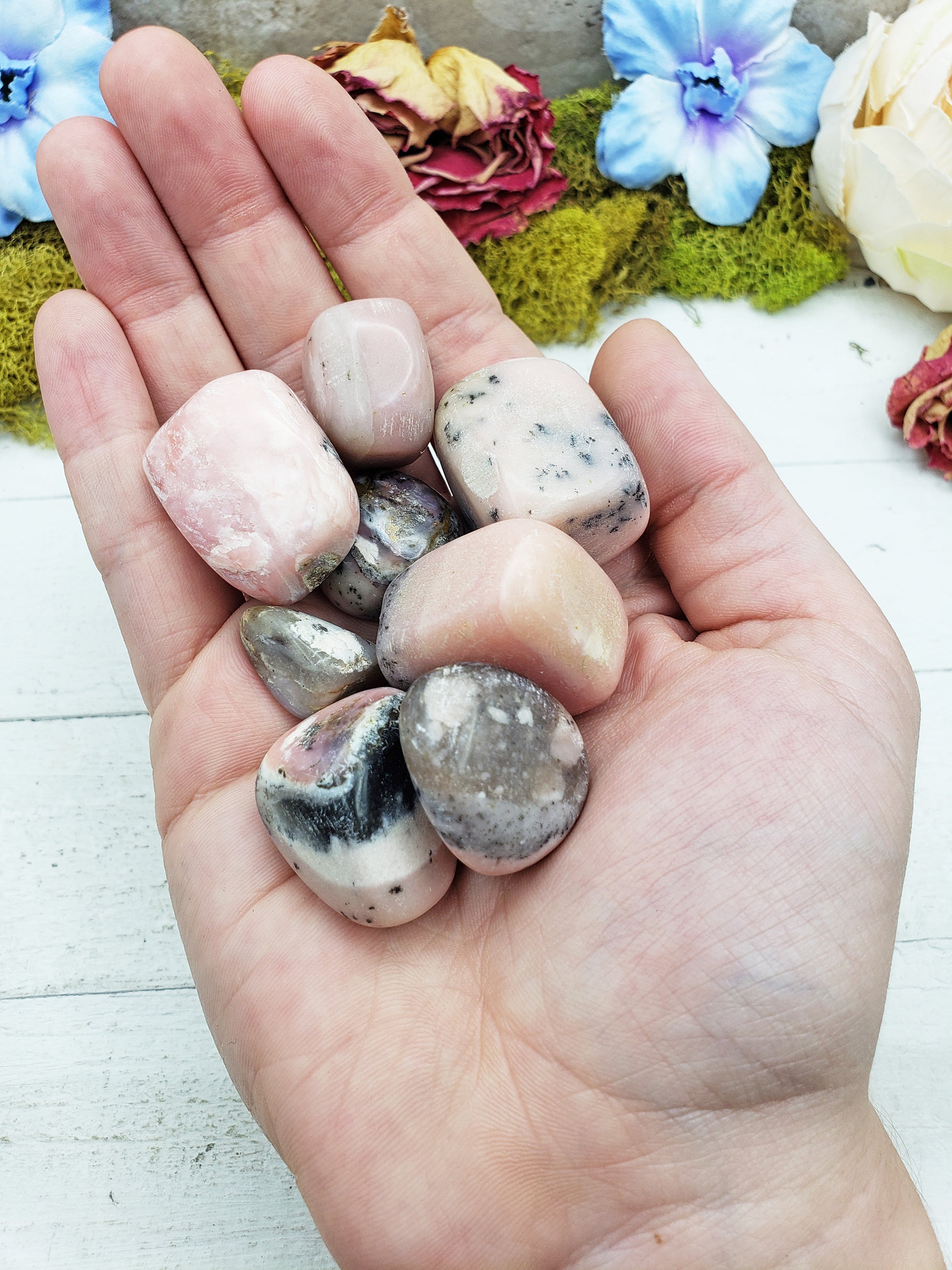 Pink Opal stones in hand