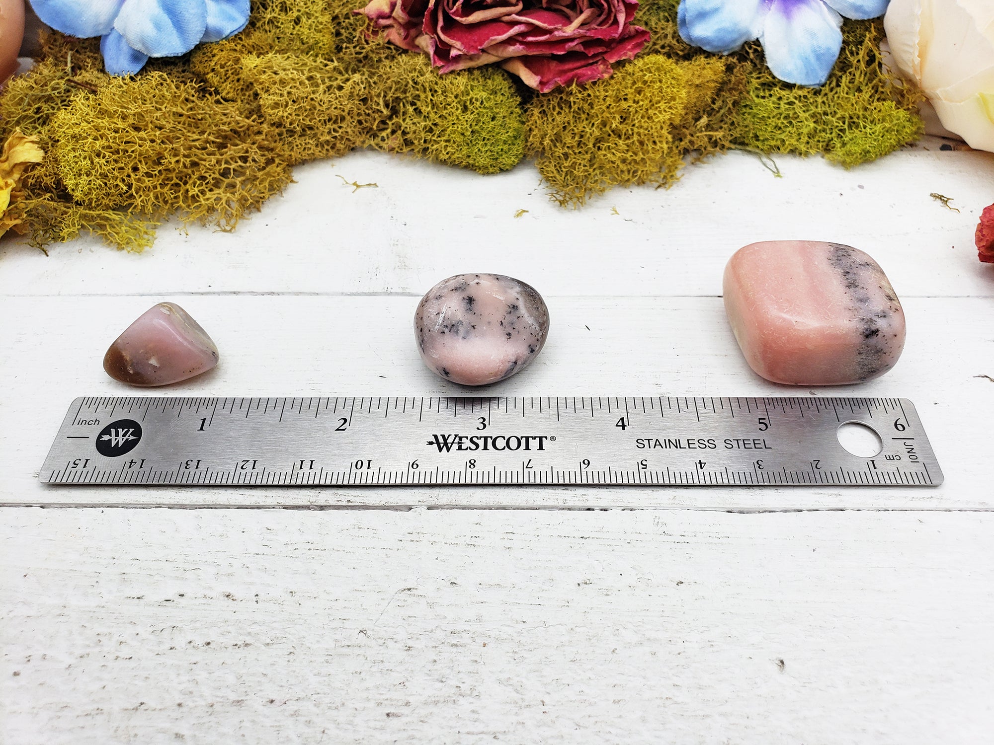 Pink Opal stones by ruler