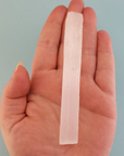 Rough Selenite Crystal Rough Stick - One 3.75 Inch Stick - Against Blue Background