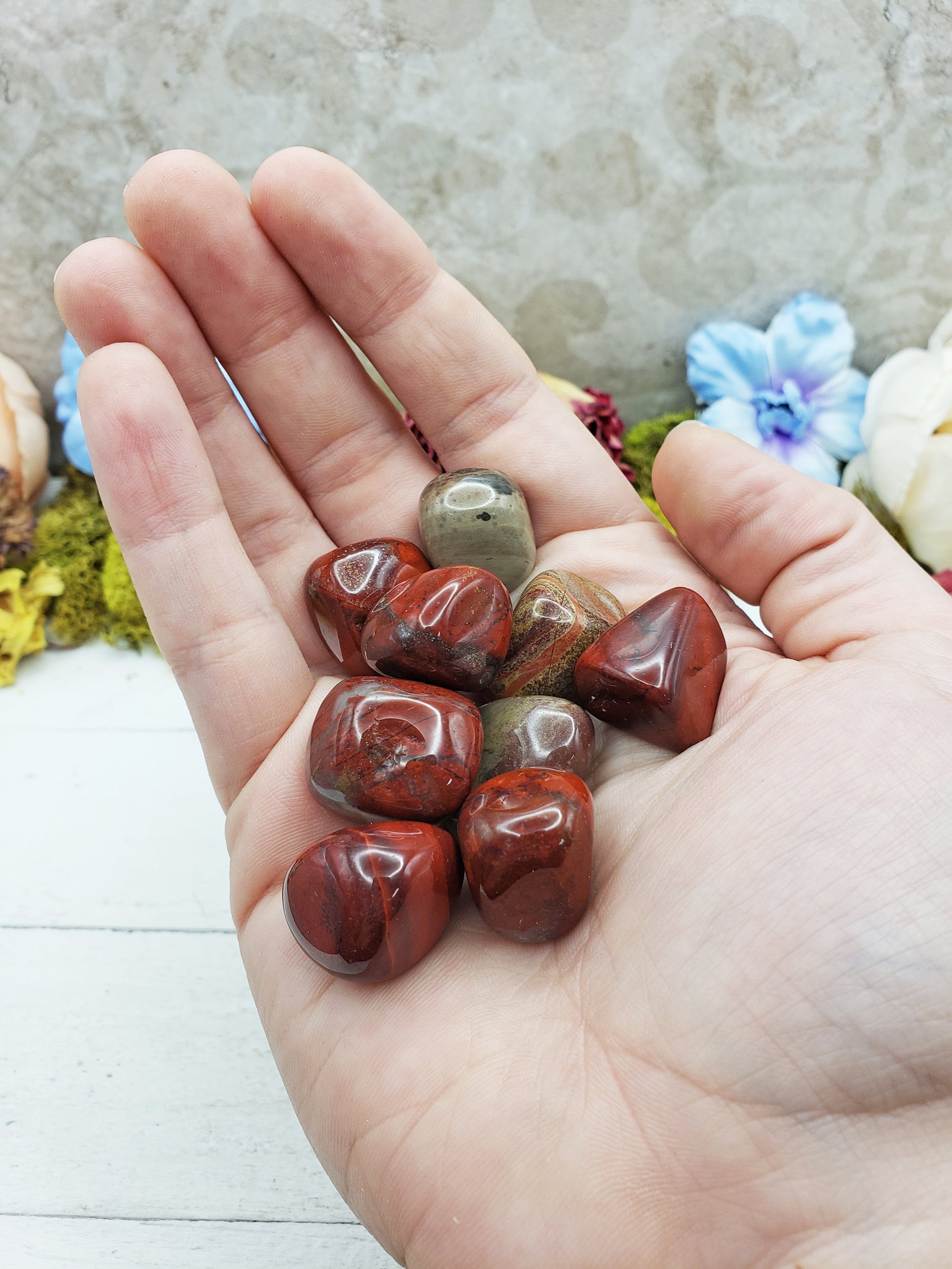 rainbow jasper stones in hand