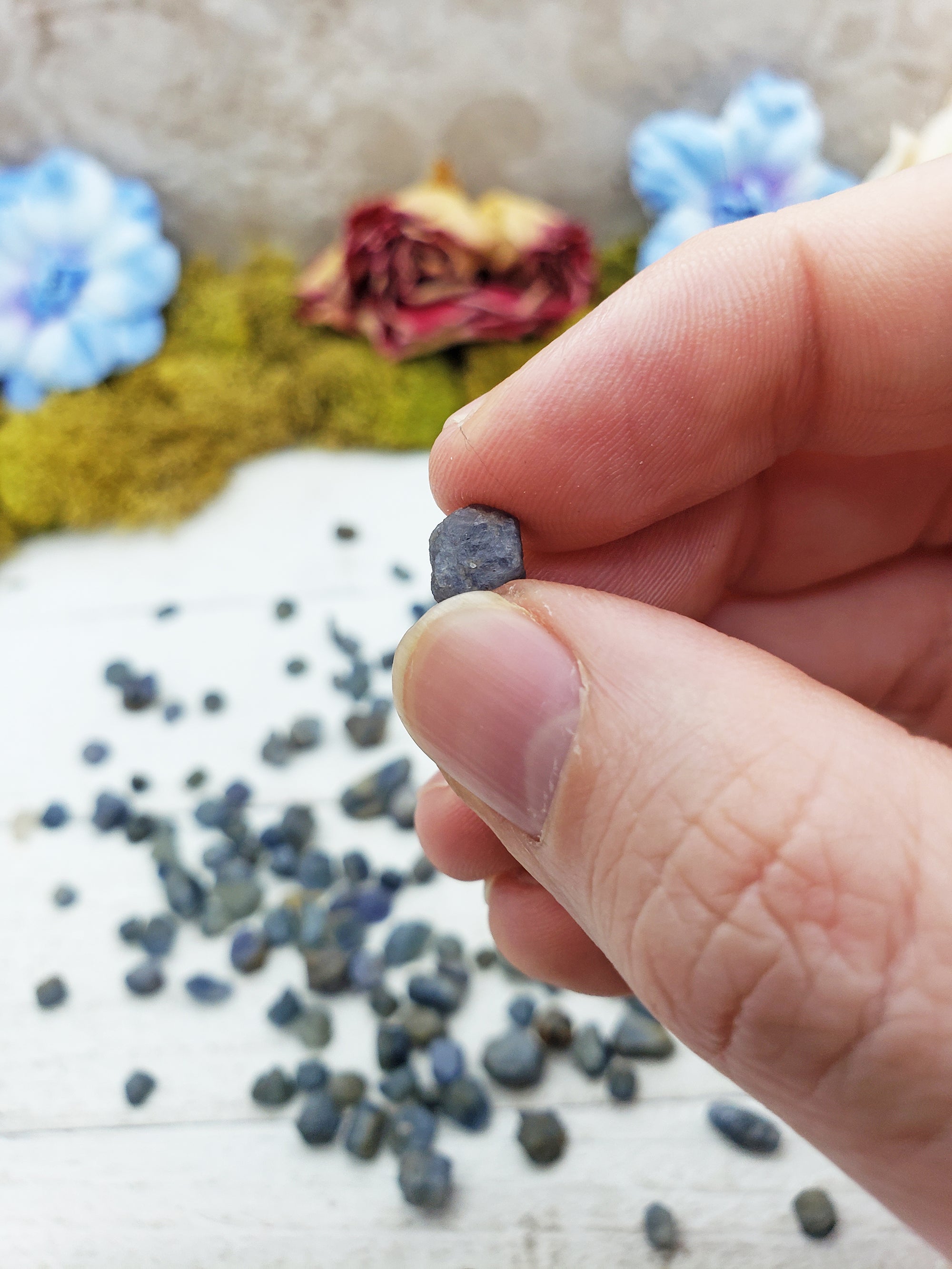 sapphire stone between fingers