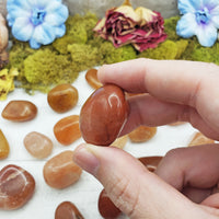 red aventurine crystals pinched between fingers