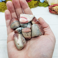 rhodocrosite crystals in hand