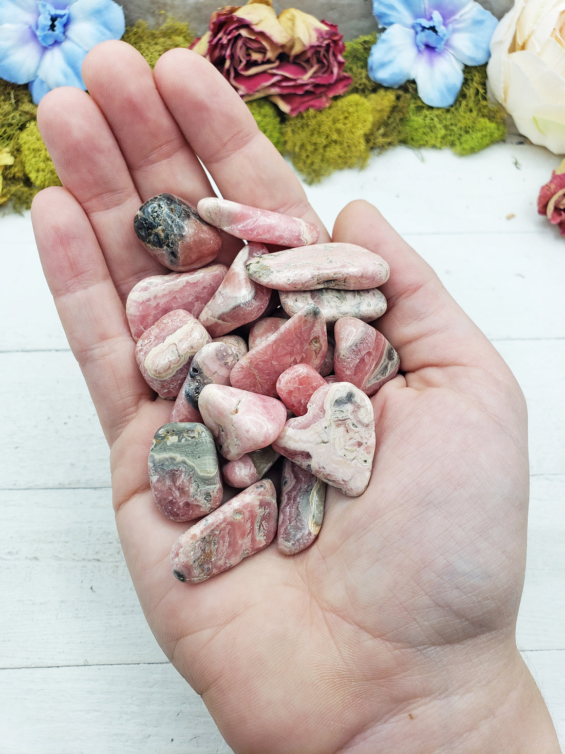 rhodocrosite stones in hand