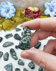 tumbled seraphinite stone between fingers