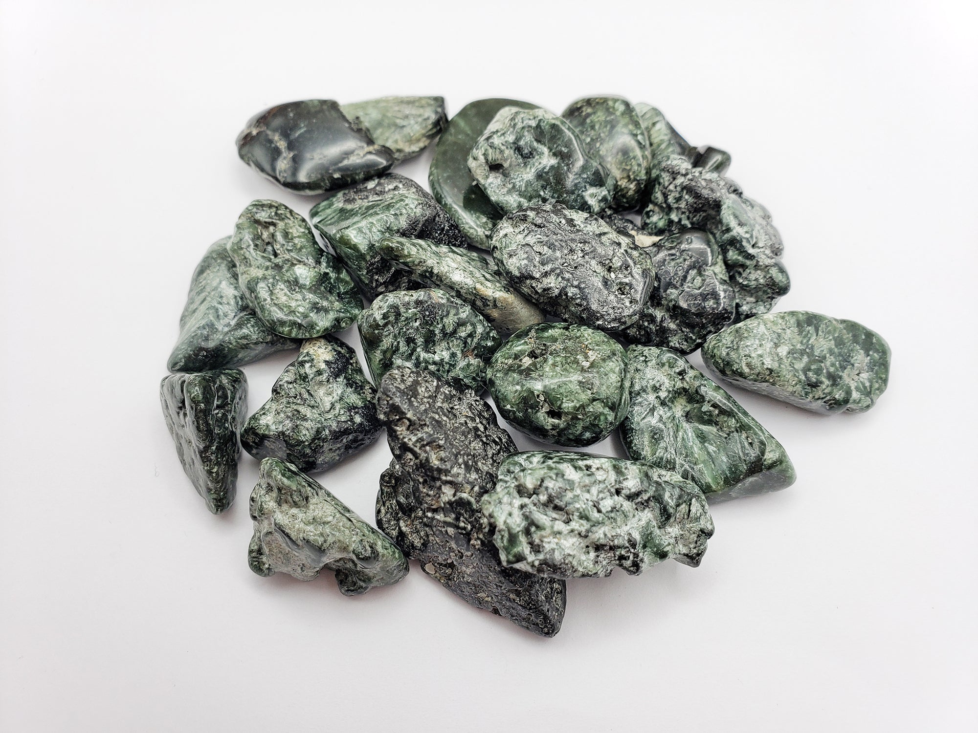 tumbled seraphinite stones on white background