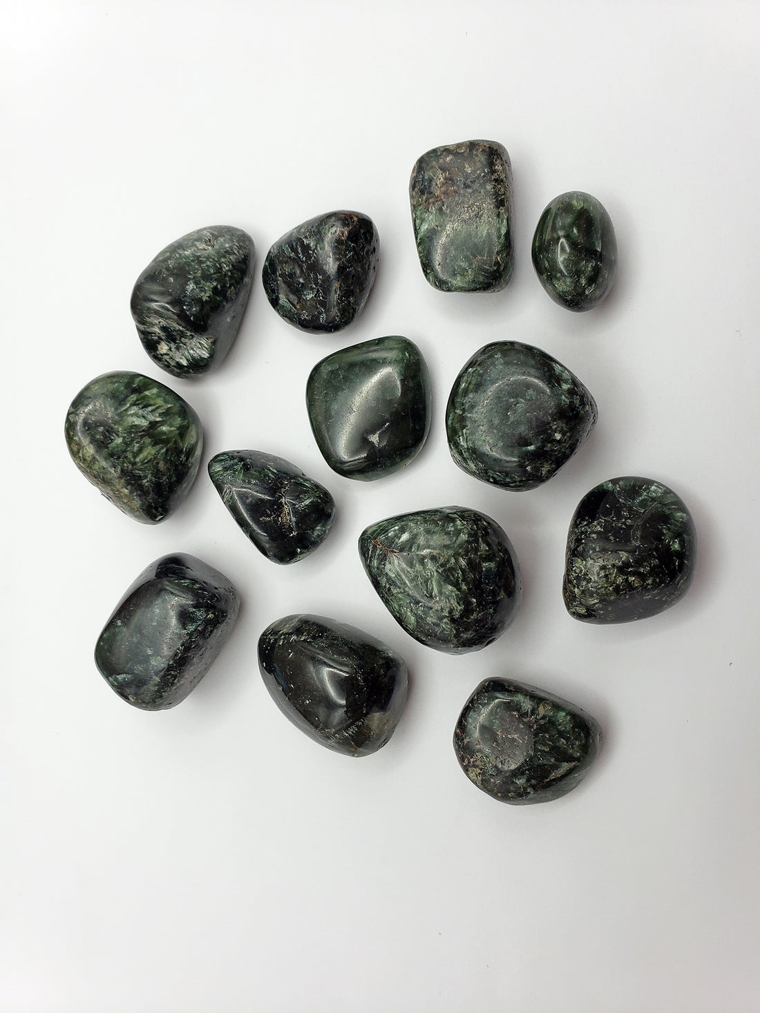 seraphinite tumbled pieces on white background