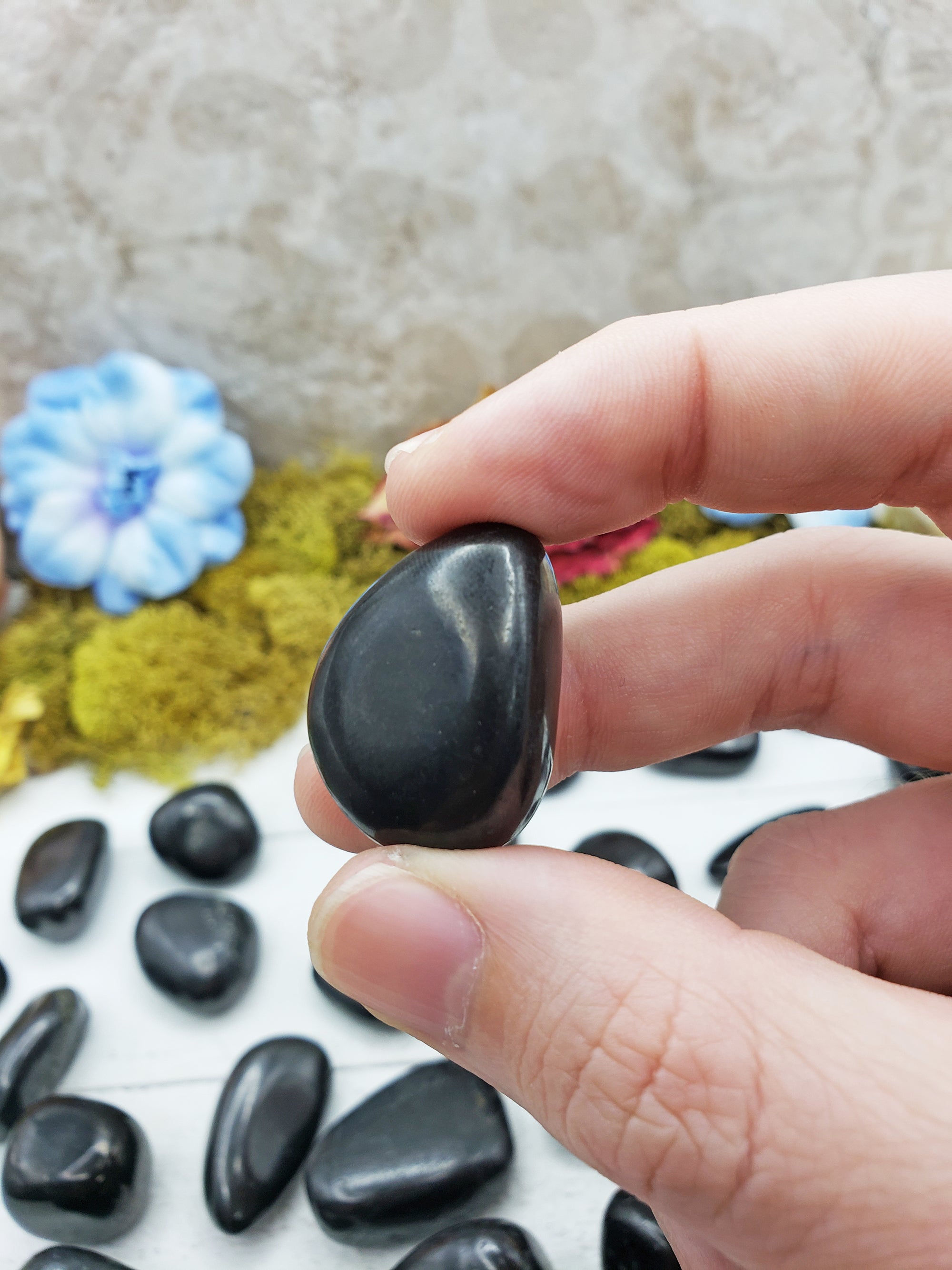 shungite stones pinched between fingers