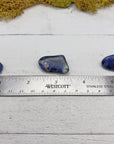ruler comparing size of 3 tumbled sodalite crystals