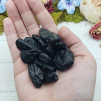 tektite stones in hand