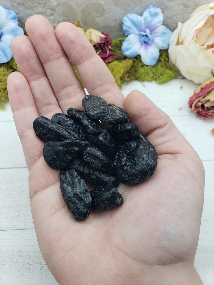 tektite stones in hand