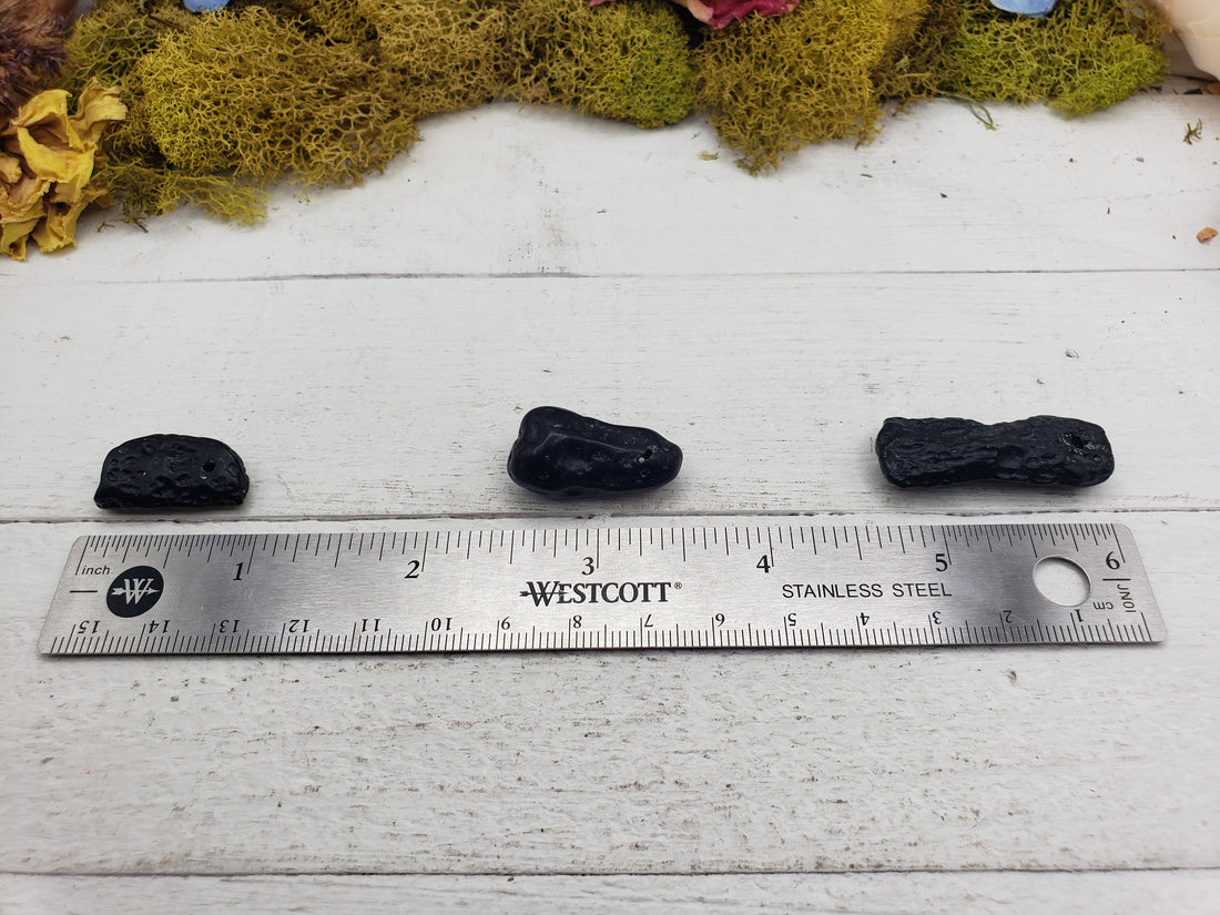 tektite stones by ruler
