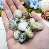 white opal stones in hand