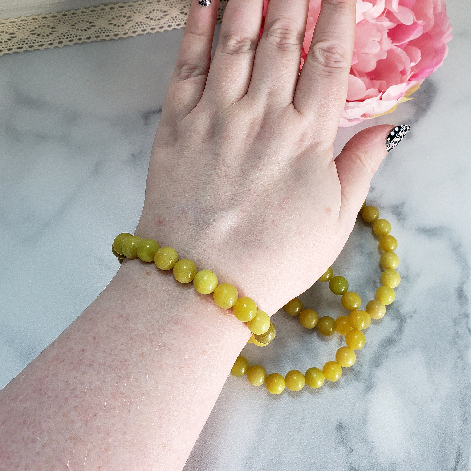 Yellow Serpentine Natural Crystal 7-8mm Bead Bracelet - Serpentine Crystal Beaded Bracelet on Wrist Above Other Bracelets