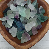 rough fluorite stones in heart-shaped bowl