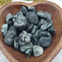 emerald in matrix stones in heart-shaped bowl